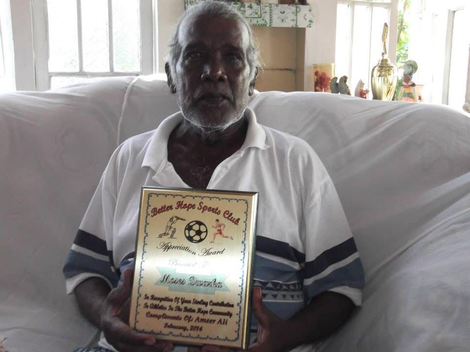 Moses Dwarka holding the BHSC Appreciation Award, February 2014